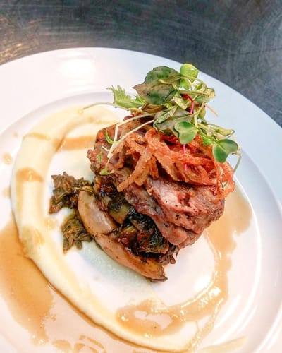 Gourmet plated dish with meat and vegetables