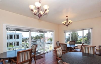 Bright dining room with large windows and tables