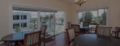 Common area with tables and large windows overlooking outdoor space