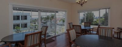 Common area with tables and large windows overlooking outdoor space