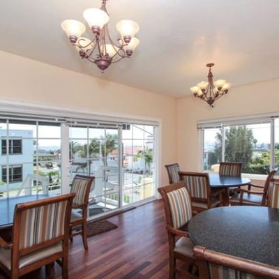 Bright dining area with large windows and wooden tables