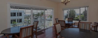 Bright common area with tables and chairs.