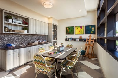Bright activity room with colorful seating and art supplies