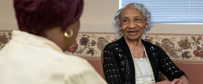 Resident smiling during conversation in a common area