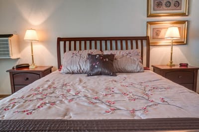 Cozy resident room with a decorated bed and lamps