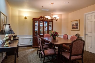 Dining room with a table and chairs for residents