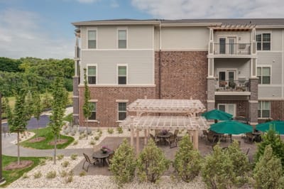 Exterior view of assisted living facility with outdoor seating