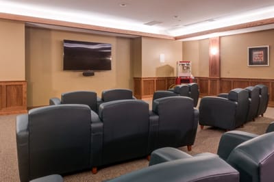 Cozy theater room with comfortable seating and a large screen