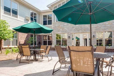 Outdoor seating area with umbrellas and a garden