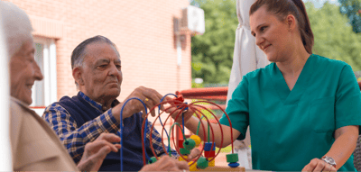 Residents engaging with staff in an outdoor activity