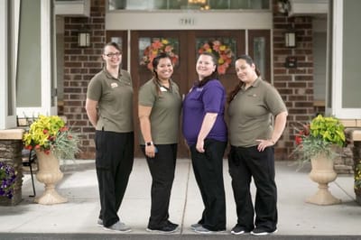 Staff members posed outside the facility entrance