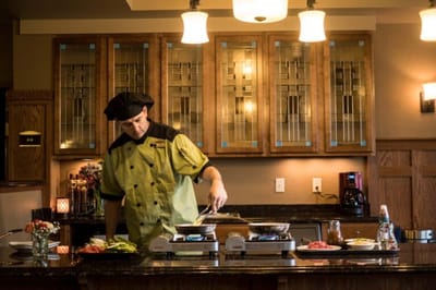 Chef preparing meals in a warm kitchen setting