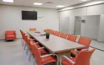 Conference room with orange chairs and a large table