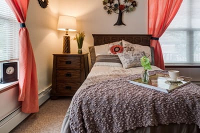 Cozy private room with warm decor and a bed