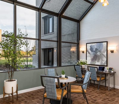 Bright common area with seating and large windows