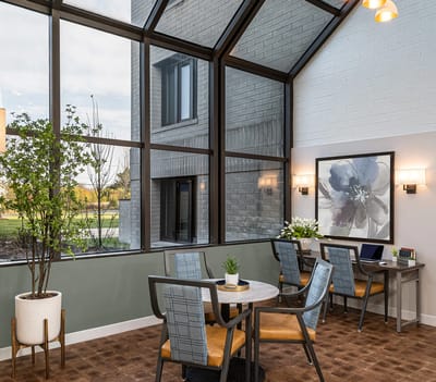 Bright common area with large windows and seating