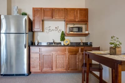 Cozy kitchenette area with wooden cabinetry
