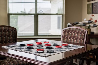 Checkers game set up on a table in a common area