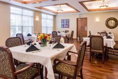 Dining room with elegantly arranged tables and flowers