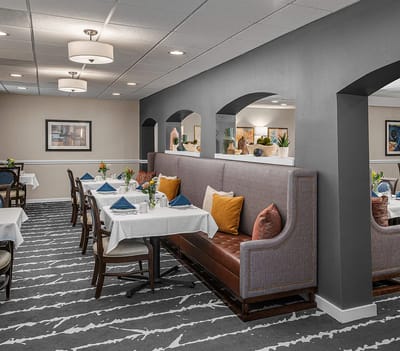 Bright dining room with tables set for meals
