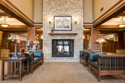 A cozy lobby area with a stone fireplace