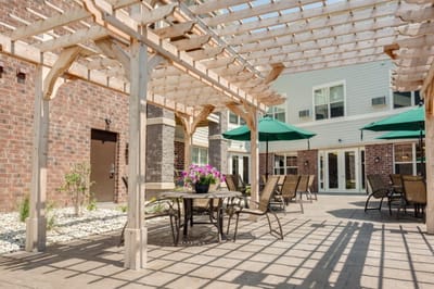Outdoor seating area with pergola and flowers