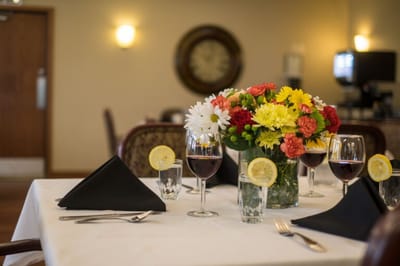 Elegant dining table set with flowers and wine glasses