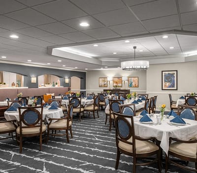 Bright dining room with elegantly set tables