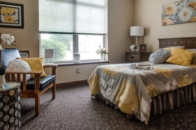 Cozy resident room with a bed and seating area
