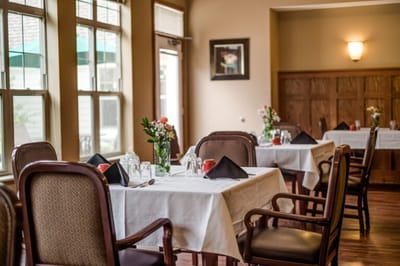 Cozy dining room setup with flowers and elegant table settings
