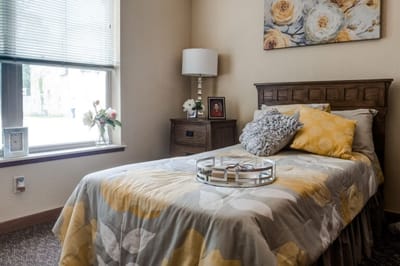Cozy resident room with floral decor and a bed