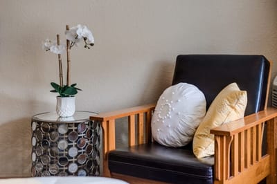 Cozy seating area with decorative pillows and flowers