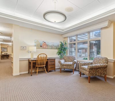 Bright common area with seating and a desk