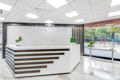 Modern reception area with white decor and plants