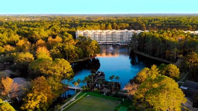Aerial view of Cypress Village with surrounding nature and water.