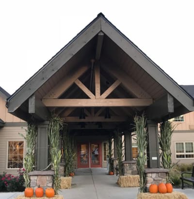 Entrance of a senior living facility decorated for autumn
