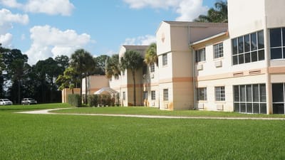 Exterior view of the facility building with landscaped grounds