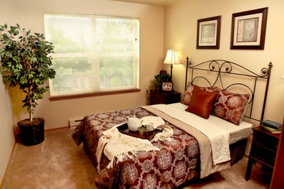Cozy private room with a decorated bed and window light