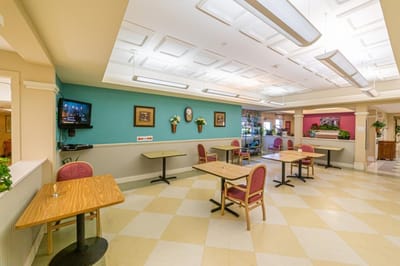 Dining area with tables and chairs in a bright room