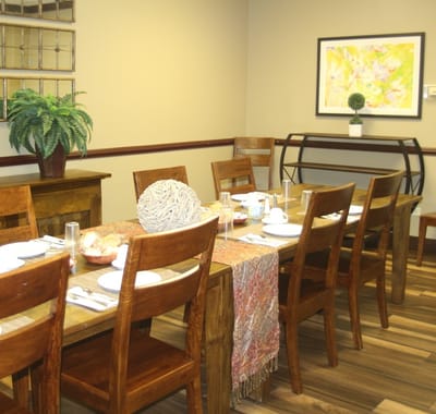 Dining room set up for a meal with wooden furniture