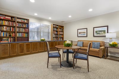 A cozy common area with bookshelves and seating