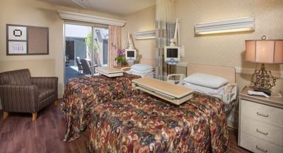 A shared resident room with two beds and a window