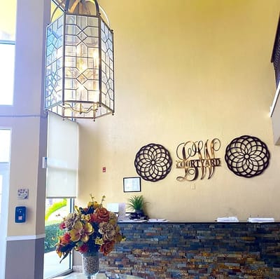 Interior lobby of Courtyard Plaza with floral arrangement