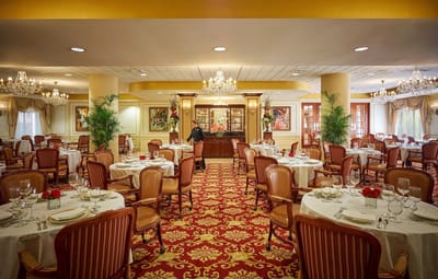 Elegant dining room with tables set for residents
