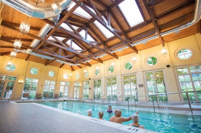 Indoor pool area with residents enjoying the water