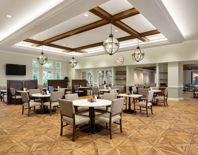 Bright dining room with tables and chairs set up for meals