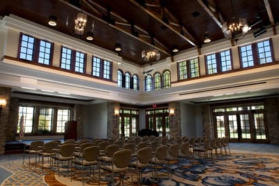 Spacious common area with elegant chandeliers and seating