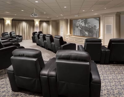 A cozy screening room with reclining chairs
