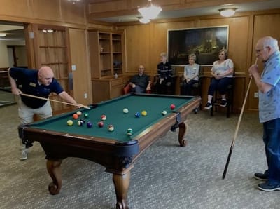 Residents enjoying a game of billiards in a lounge