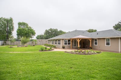 Outdoor view of the facility with green lawn and seating area